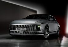 a silver car parked in a dark room