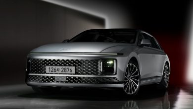 a silver car parked in a dark room